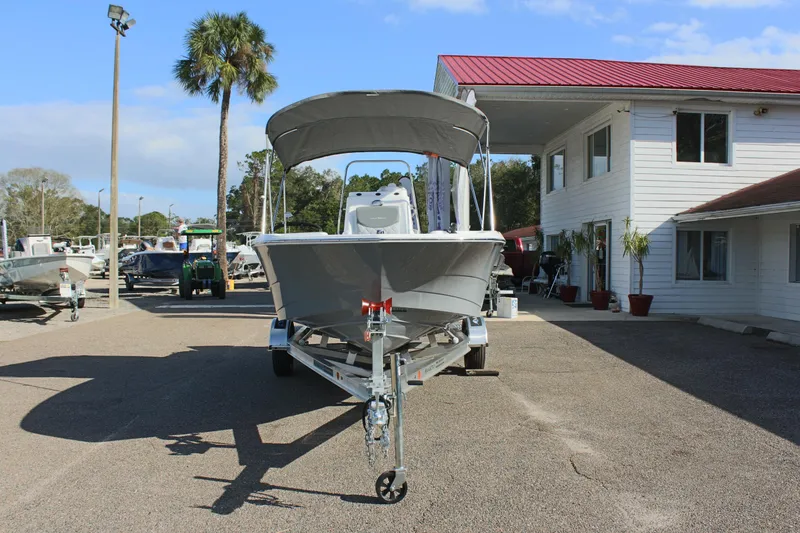 Slide: The Image of 2025 NauticStar 191 Hybrid boat on trailer in marina parking lot. - 3