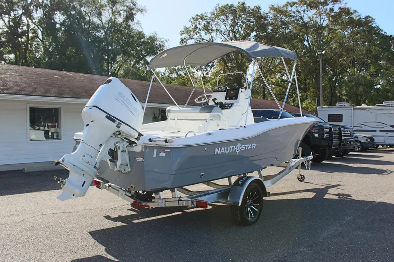 Slide: The Image of 2025 NauticStar 191 Hybrid boat on trailer, parked outdoors. - 6