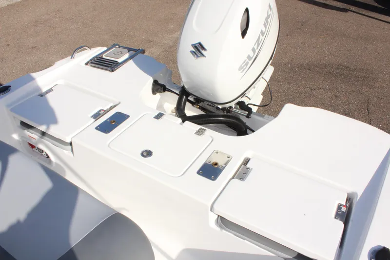 Slide: The Image of 2025 NauticStar 191 Hybrid boat with Suzuki outboard motor, featuring storage compartments. - 9