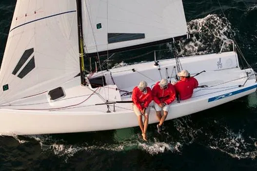 Slide: The Image of 2026 J Boats J/70 sailing with crew in red jackets on open water. - 3