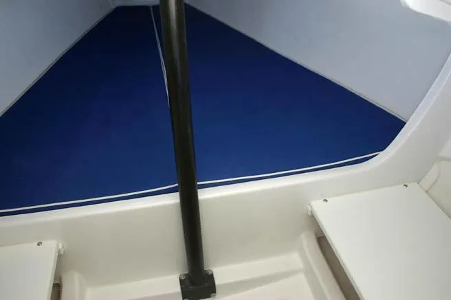 Slide: The Image of Interior view of 2026 J Boats J/70 sailboat with blue cushioned seating. - 5