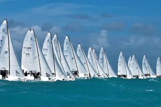 Slide: The Image of Fleet of 2026 J Boats J/70 sailboats racing on turquoise waters under clear skies. - 8