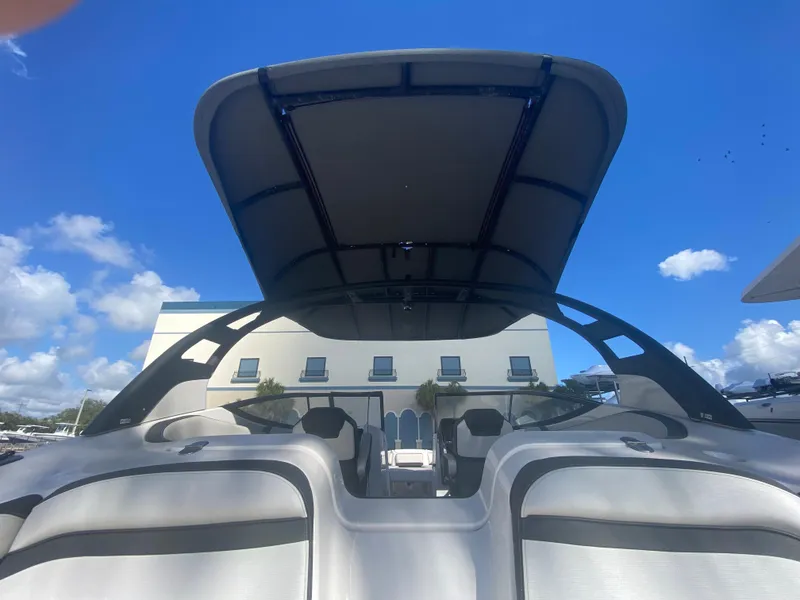 Slide: The Image of 2018 Yamaha Boats 242 Limited S with canopy against blue sky. - 3
