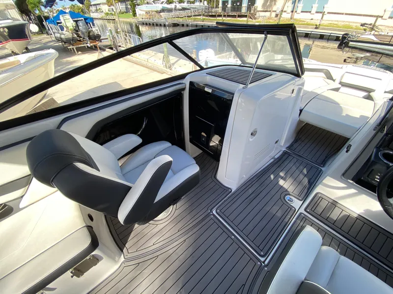 Slide: The Image of 2018 Yamaha Boats 242 Limited S interior with sleek seating and modern dashboard. - 6