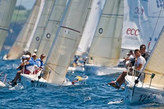 Slide: The Image of Sailboats racing on the ocean, featuring 2026 J Boats J/80 models. - 2