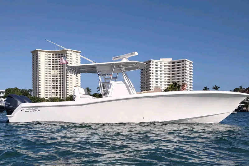 The Image of 2017 Invincible 33 Open Fisherman boat on water, with city skyline background. - 0