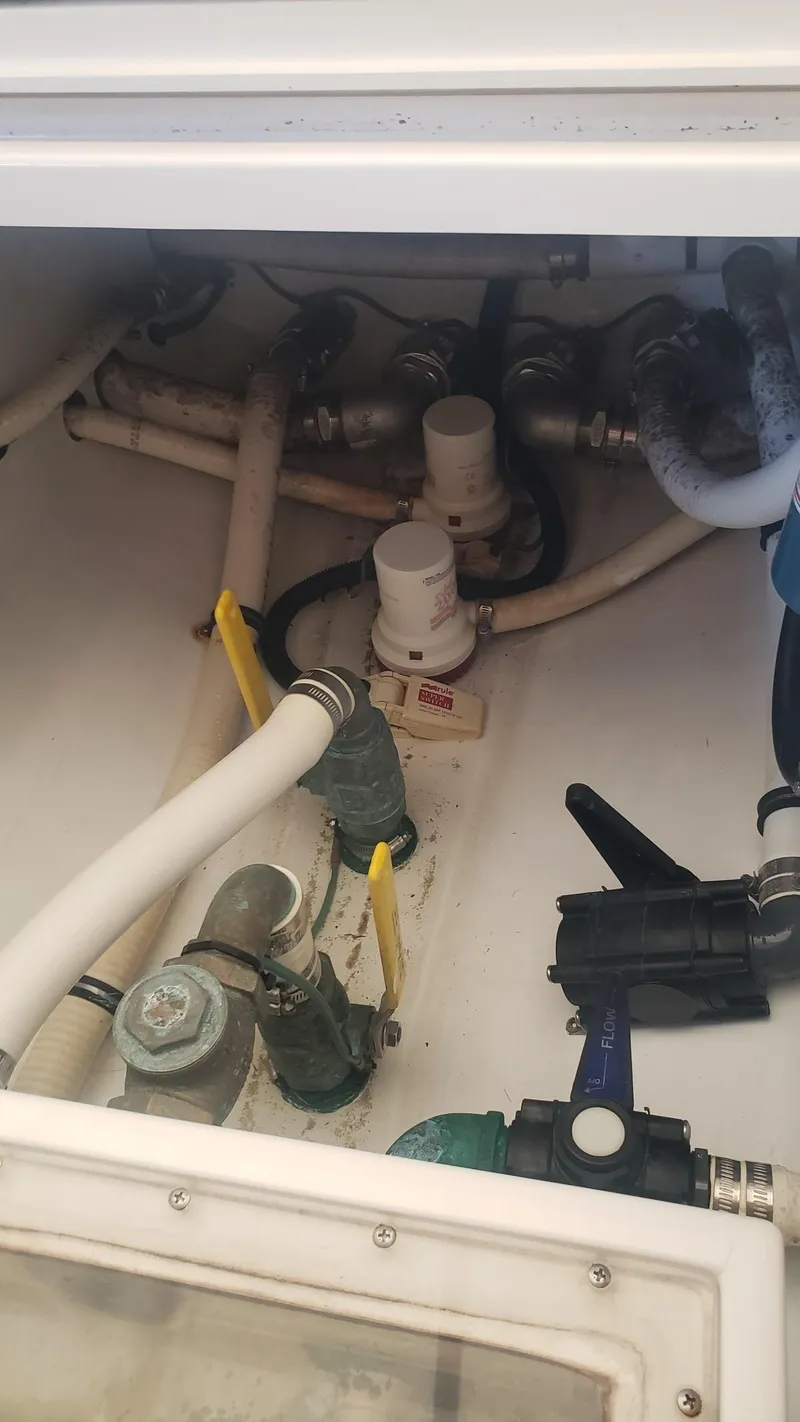 Slide: The Image of 2017 Invincible 33 Open Fisherman boat plumbing system with valves and hoses. - 19