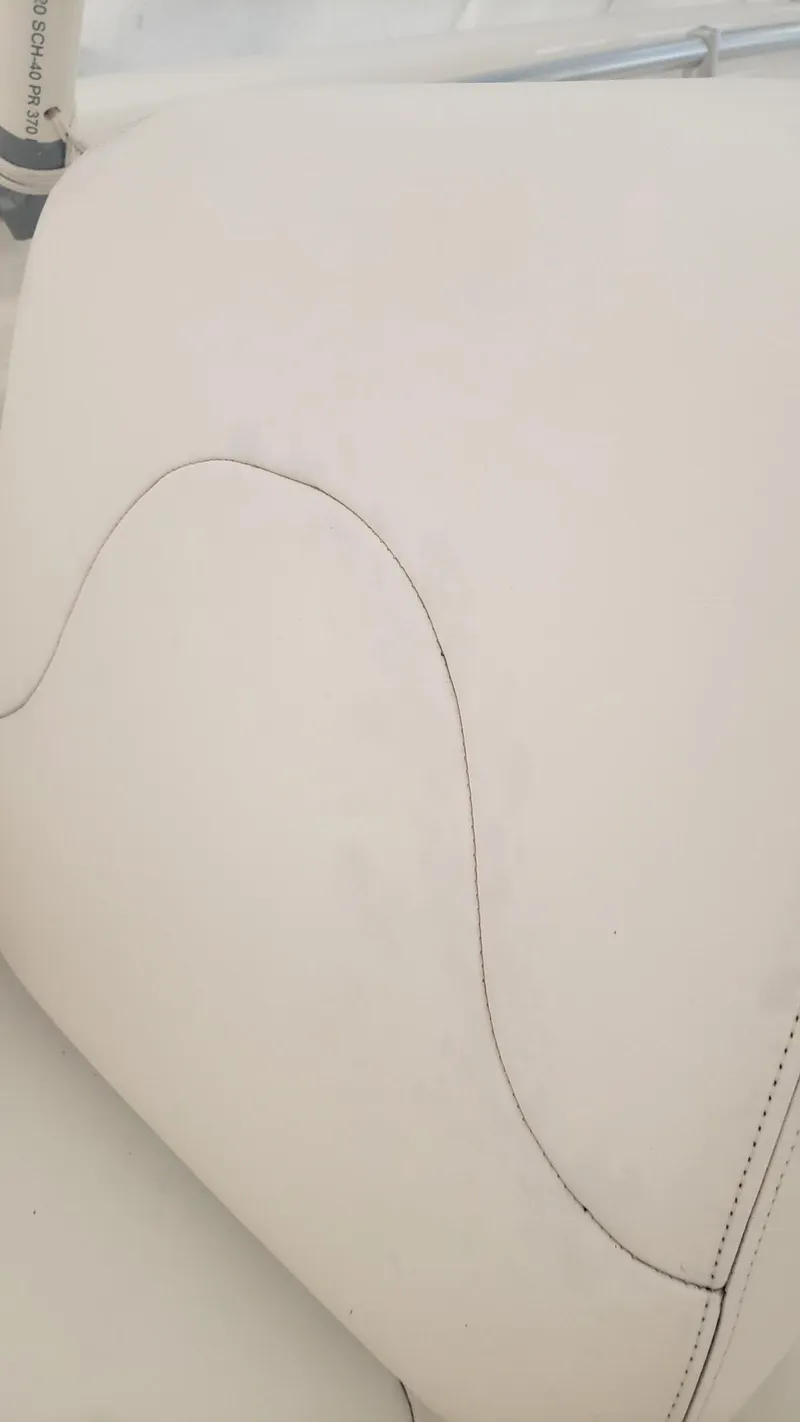 Slide: The Image of Close-up of 2017 Invincible 33 Open Fisherman boat seat with white upholstery. - 21