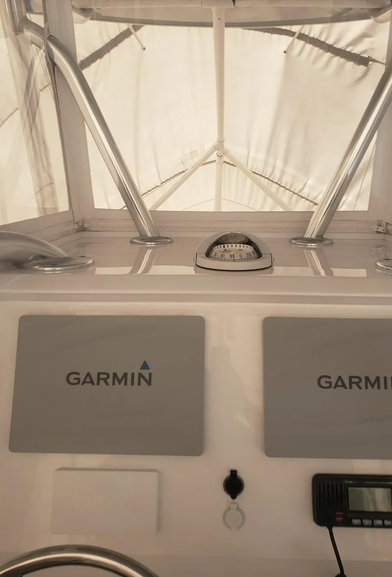 Slide: The Image of 2017 Invincible 33 Open Fisherman dashboard with Garmin navigation equipment. - 23