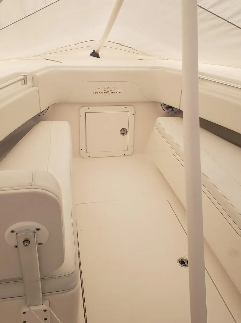 Slide: The Image of 2017 Invincible 33 Open Fisherman boat interior with white seating and storage. - 31