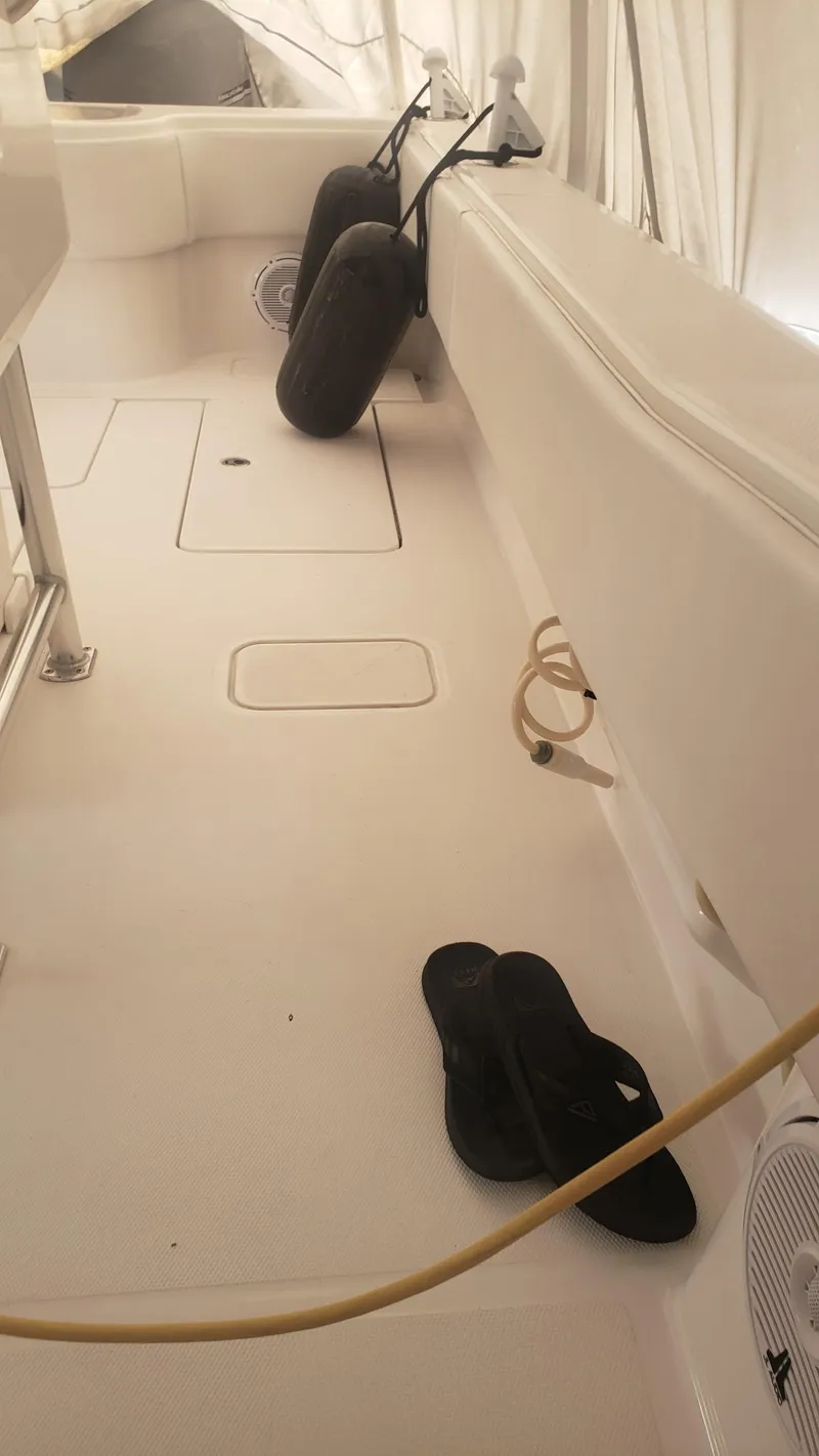 Slide: The Image of 2017 Invincible 33 Open Fisherman boat deck with fenders and flip-flops. - 33