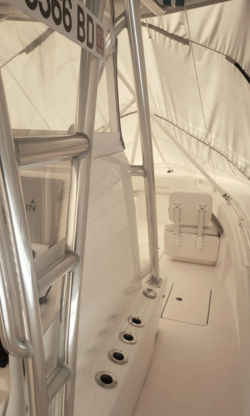 Slide: The Image of 2017 Invincible 33 Open Fisherman boat interior with rod holders and seating. - 39