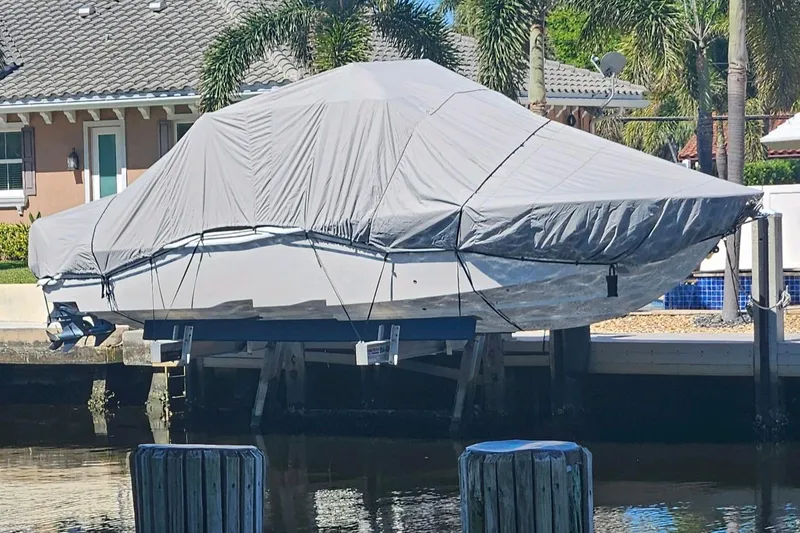 Slide: The Image of Covered 2017 Invincible 33 Open Fisherman boat docked near waterfront home. - 5