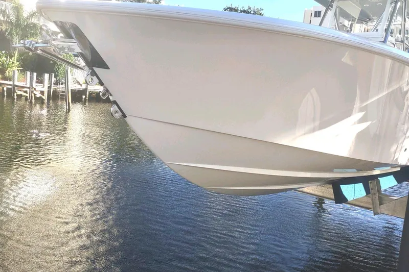 Slide: The Image of 2017 Invincible 33 Open Fisherman boat on water, side view. - 8