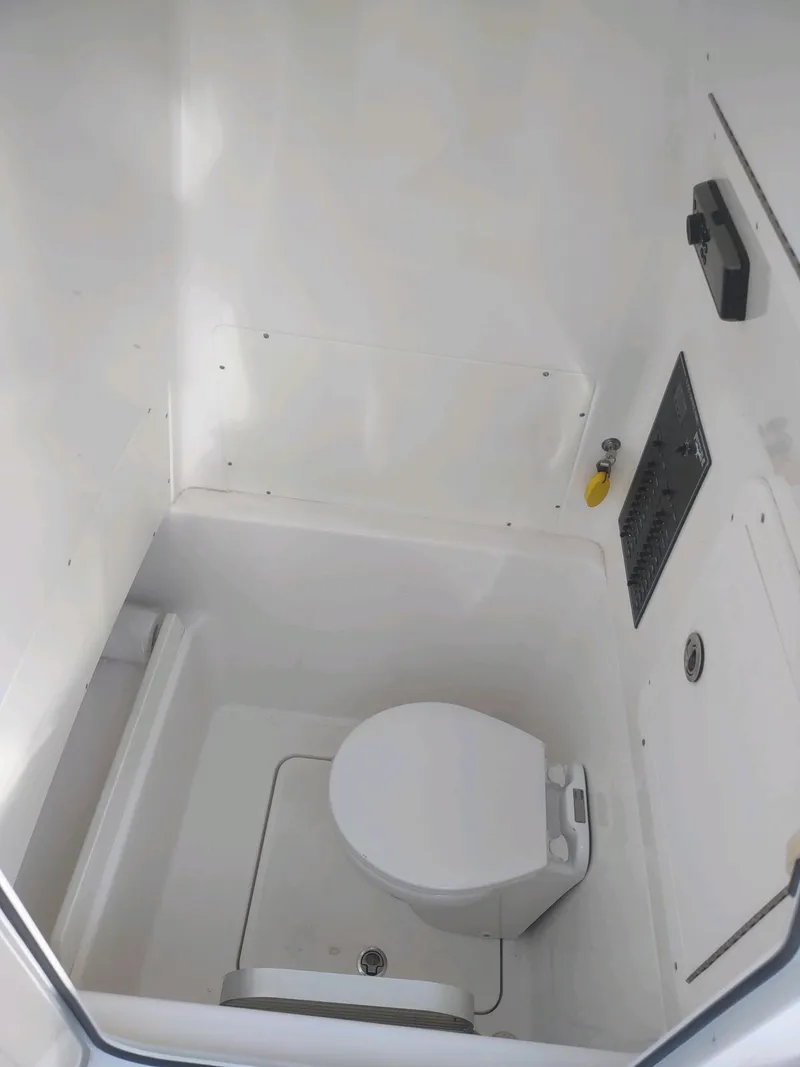 Slide: The Image of 2017 Invincible 33 Open Fisherman boat interior with compact marine toilet. - 9