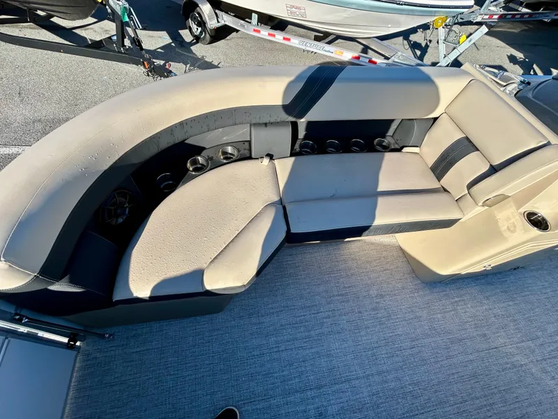 Slide: The Image of 2024 Berkshire 22CL2 CTS boat interior with beige seating and cup holders. - 12