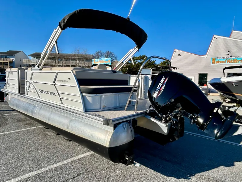 Slide: The Image of 2024 Berkshire 22CL2 CTS pontoon boat with Mercury outboard motor, parked outdoors. - 13