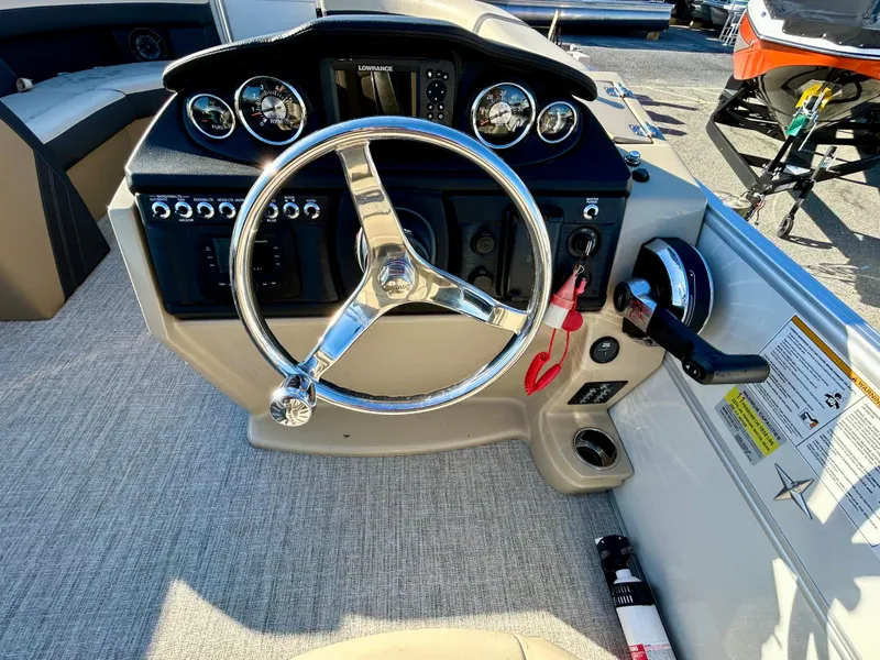 Slide: The Image of 2024 Berkshire 22CL2 CTS boat dashboard with steering wheel and control panel. - 14