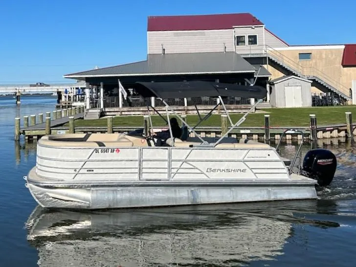 Slide: The Image of 2024 Berkshire 22CL2 CTS pontoon boat on water near dockside building. - 15