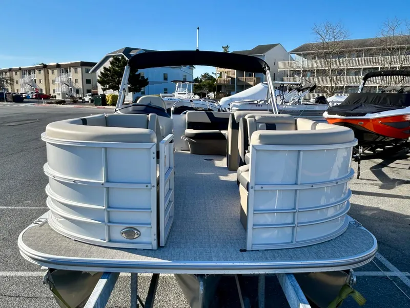 Slide: The Image of 2024 Berkshire 22CL2 CTS pontoon boat with spacious seating, docked in a marina. - 2