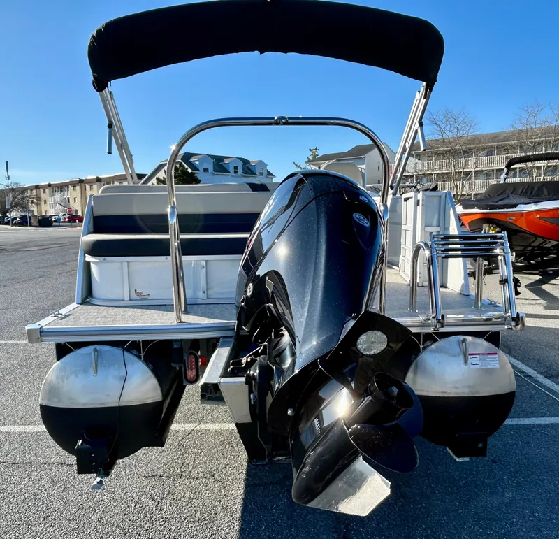 Slide: The Image of 2024 Berkshire 22CL2 CTS pontoon boat with outboard motor, parked outdoors. - 4