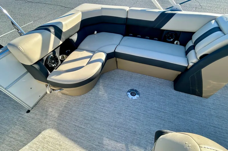 Slide: The Image of 2024 Berkshire 22CL2 CTS boat interior with beige and black seating arrangement. - 7