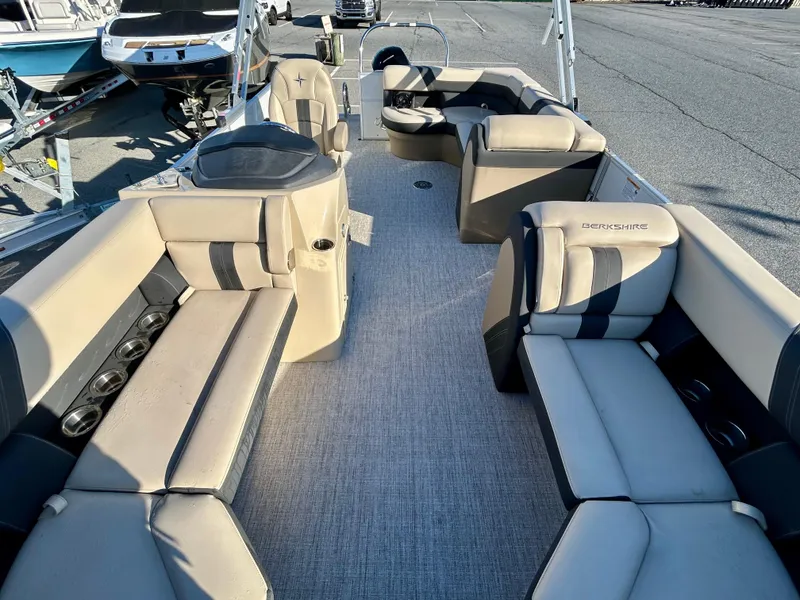 Slide: The Image of 2024 Berkshire 22CL2 CTS pontoon boat interior with beige seating and spacious layout. - 9