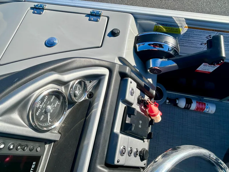 Slide: The Image of 2024 Berkshire 23RFX STS 3.0 boat dashboard with controls and gauges. - 13