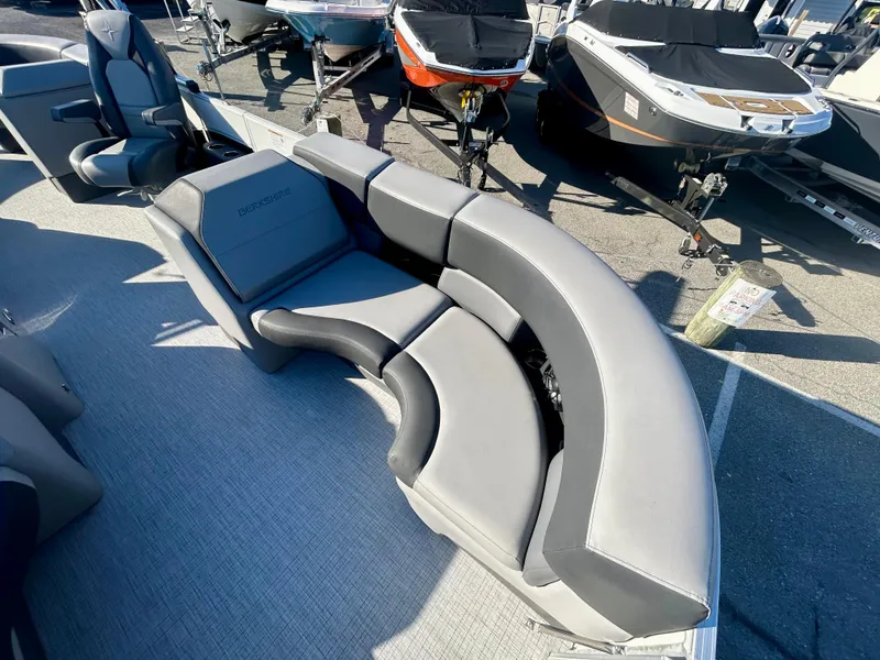 Slide: The Image of 2024 Berkshire 23RFX STS 3.0 boat with luxurious gray seating, docked outdoors. - 16