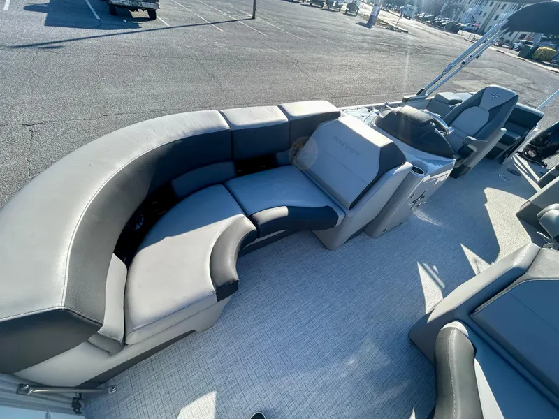 Slide: The Image of 2024 Berkshire 23RFX STS 3.0 pontoon boat with luxurious seating in a parking lot. - 17