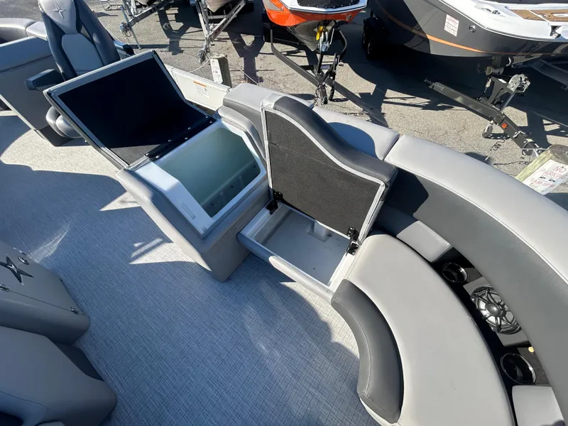 Slide: The Image of 2024 Berkshire 23RFX STS 3.0 boat interior with seating and storage compartments. - 18