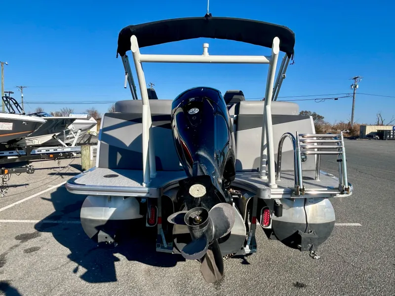 Slide: The Image of 2024 Berkshire 23RFX STS 3.0 pontoon boat with outboard motor, rear view. - 22