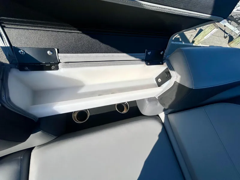 Slide: The Image of 2024 Berkshire 23RFX STS 3.0 boat seat storage compartment with cup holders. - 8