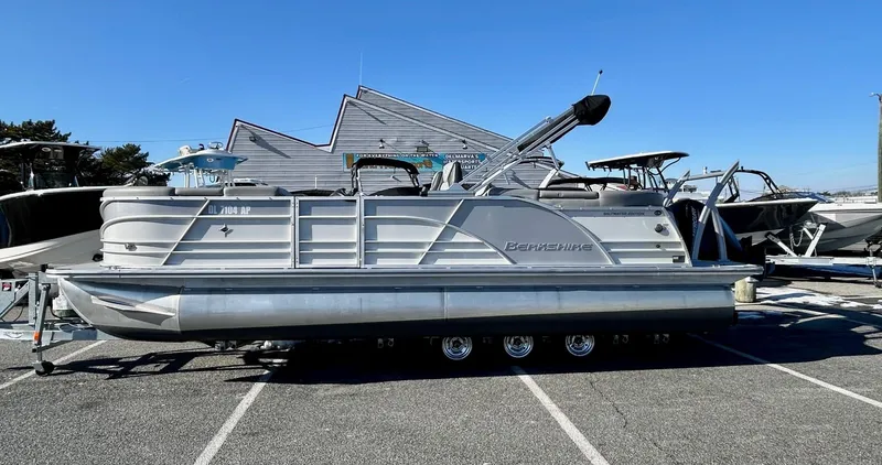 Slide: The Image of 2024 Berkshire 23RFX STS 2.75 pontoon boat parked in a marina. - 0