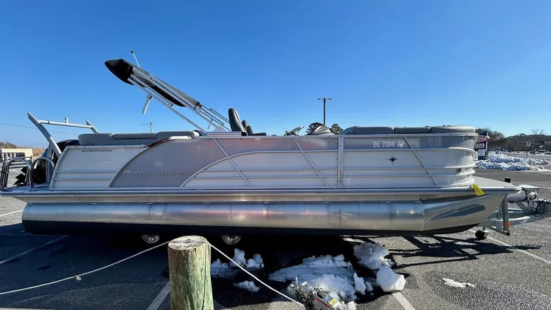 Slide: The Image of 2024 Berkshire 23RFX STS 2.75 pontoon boat parked on a sunny day. - 1