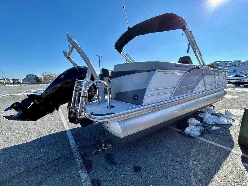 Slide: The Image of 2024 Berkshire 23RFX STS 2.75 pontoon boat parked on asphalt with snow patches. - 17