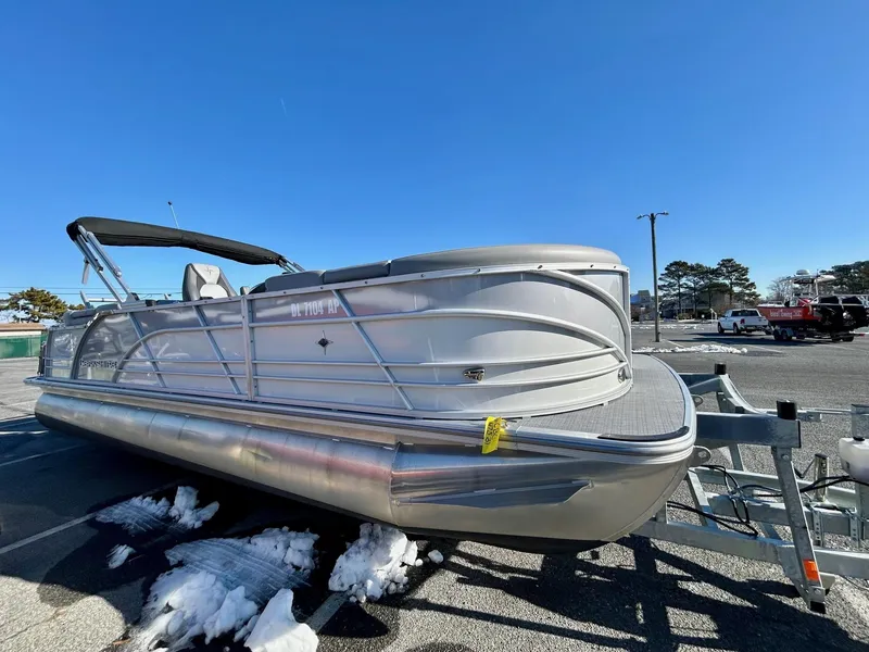 Slide: The Image of 2024 Berkshire 23RFX STS 2.75 pontoon boat on trailer in parking lot. - 2