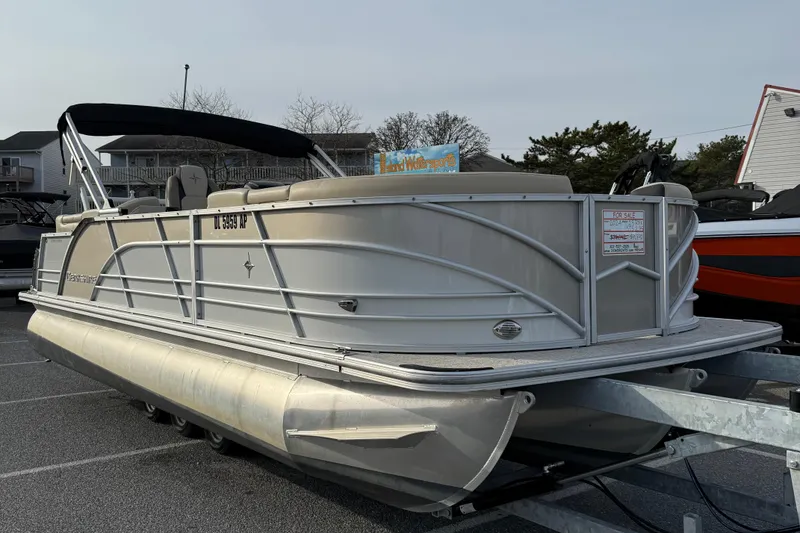 Slide: The Image of 2024 Berkshire 23RFX STS pontoon boat on trailer, parked outdoors. - 11