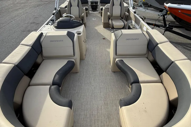 Slide: The Image of 2024 Berkshire 23RFX STS pontoon boat interior with beige and black seating. - 18