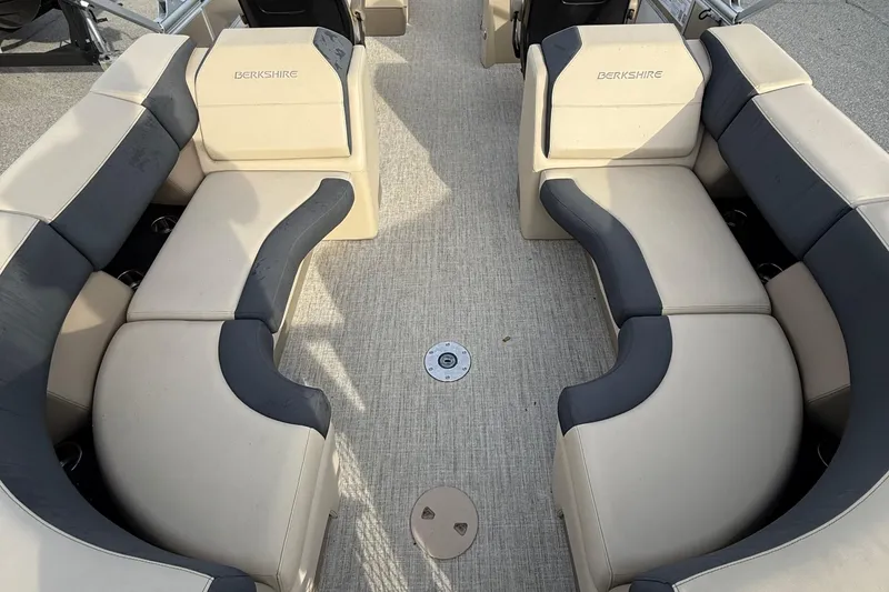 Slide: The Image of 2024 Berkshire 23RFX STS boat interior with beige and gray seating arrangement. - 20