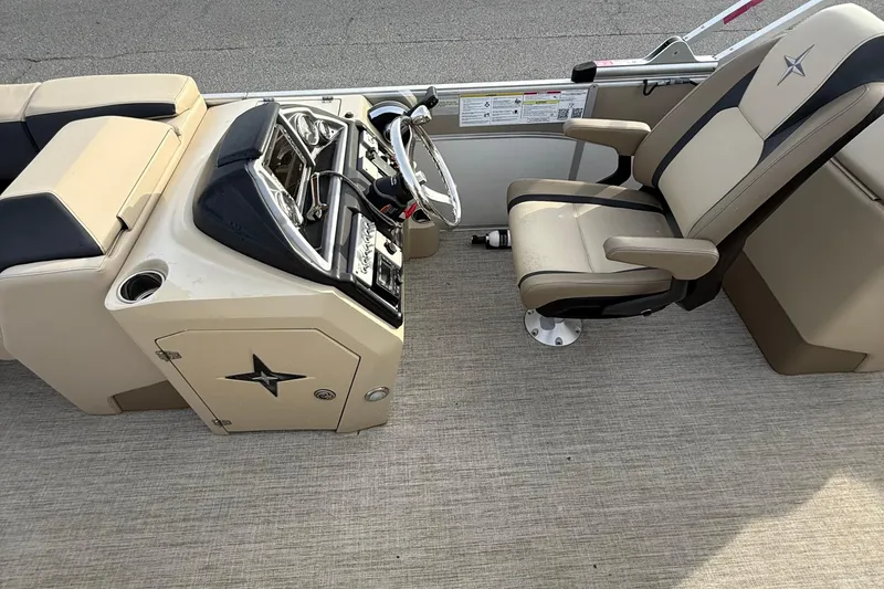 Slide: The Image of 2024 Berkshire 23RFX STS boat interior with beige captain's chair and control console. - 21