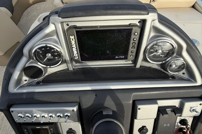 Slide: The Image of 2024 Berkshire 23RFX STS dashboard with Lowrance Elite display and gauges. - 22