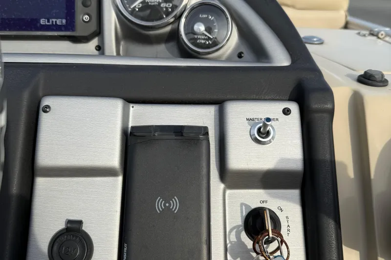 Slide: The Image of Control panel of 2024 Berkshire 23RFX STS boat with switches and gauges. - 24