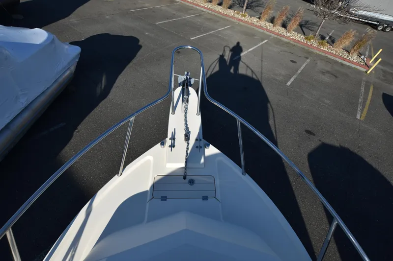 Slide: The Image of Parker 2320 SL Sport Cabin 2013 boat bow view in parking lot. - 13