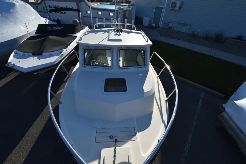 Slide: The Image of 2013 Parker 2320 SL Sport Cabin boat, docked, front view. - 14