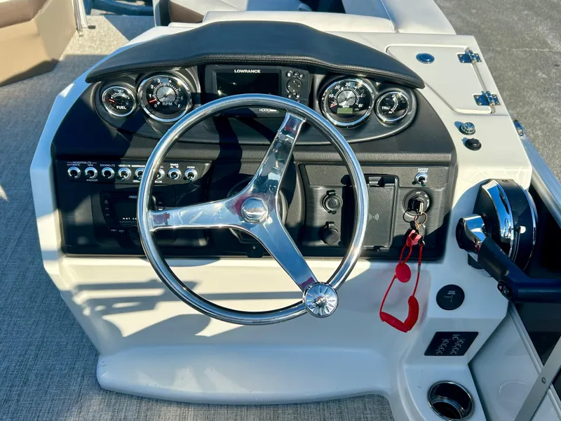 Slide: The Image of Steering console of 2024 Berkshire 24RFC CTS 2.75 boat with gauges and controls. - 15