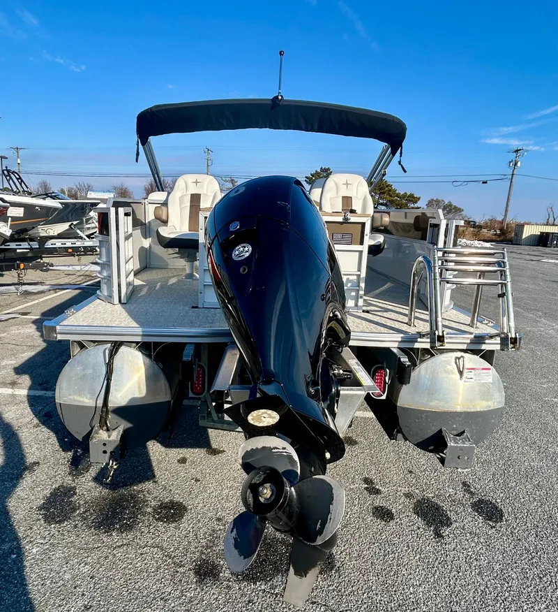 Slide: The Image of 2024 Berkshire 24RFC CTS 2.75 pontoon boat with outboard motor, rear view. - 6