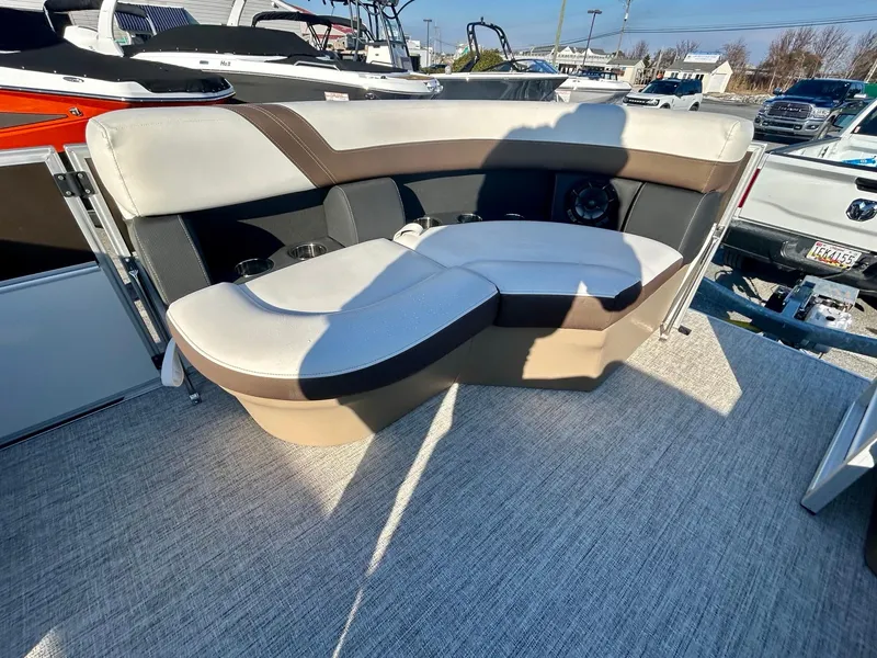 Slide: The Image of 2024 Berkshire 24RFC CTS 2.75 boat interior with beige and brown seating. - 9