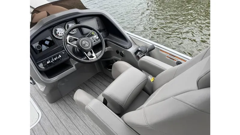 Slide: The Image of 2023 Avalon 2585 VRB boat cockpit with modern steering and controls, on water. - 12