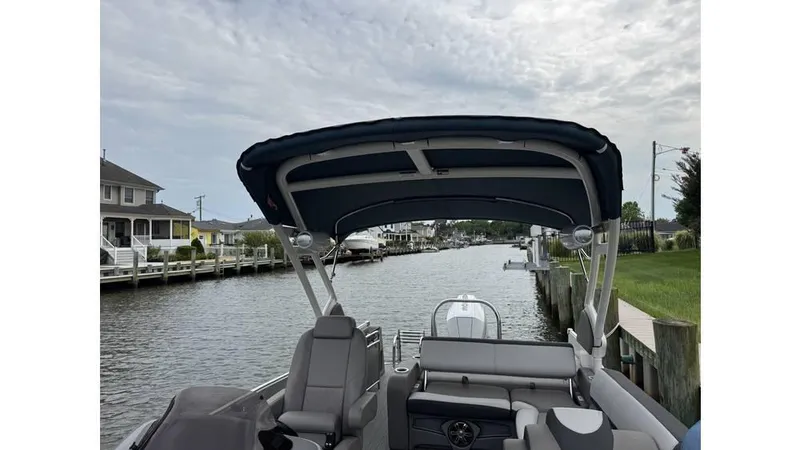 Slide: The Image of 2023 Avalon 2585 VRB boat with canopy on a calm canal. - 18